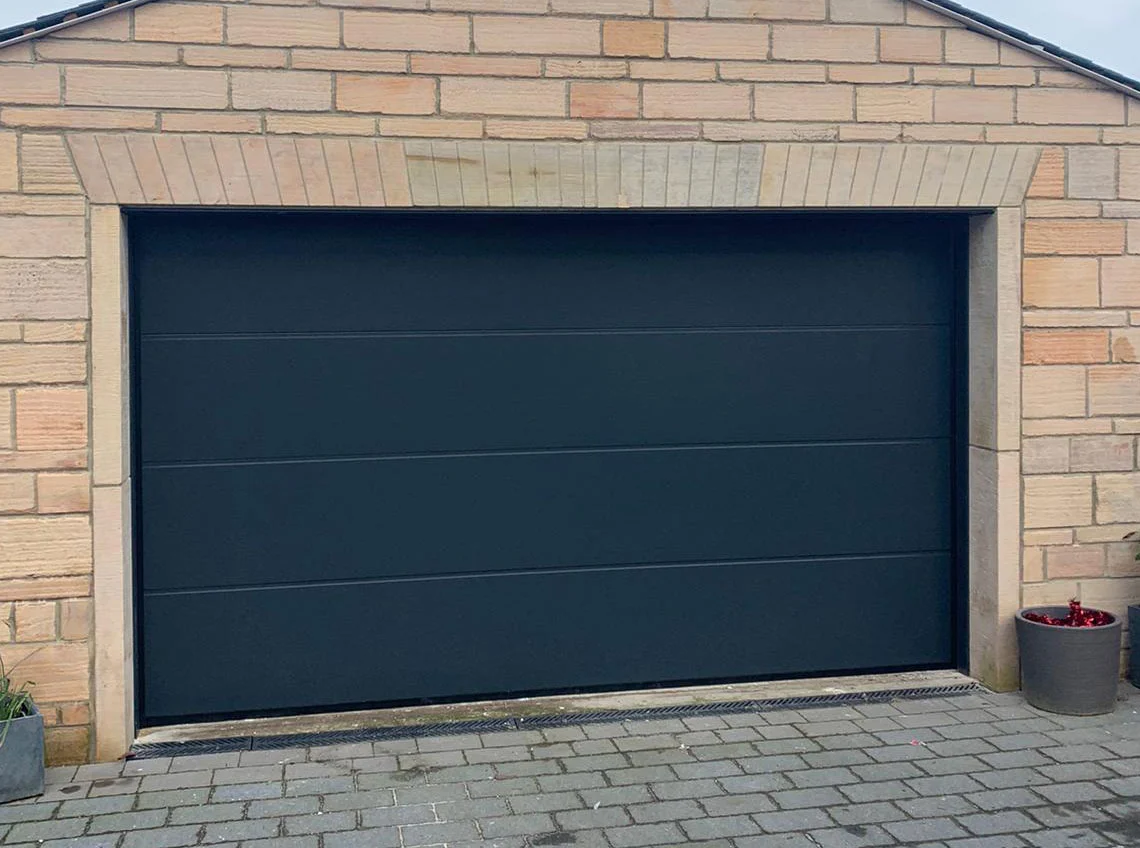 Anthracite Alutech sectional garage door fitted to a home
