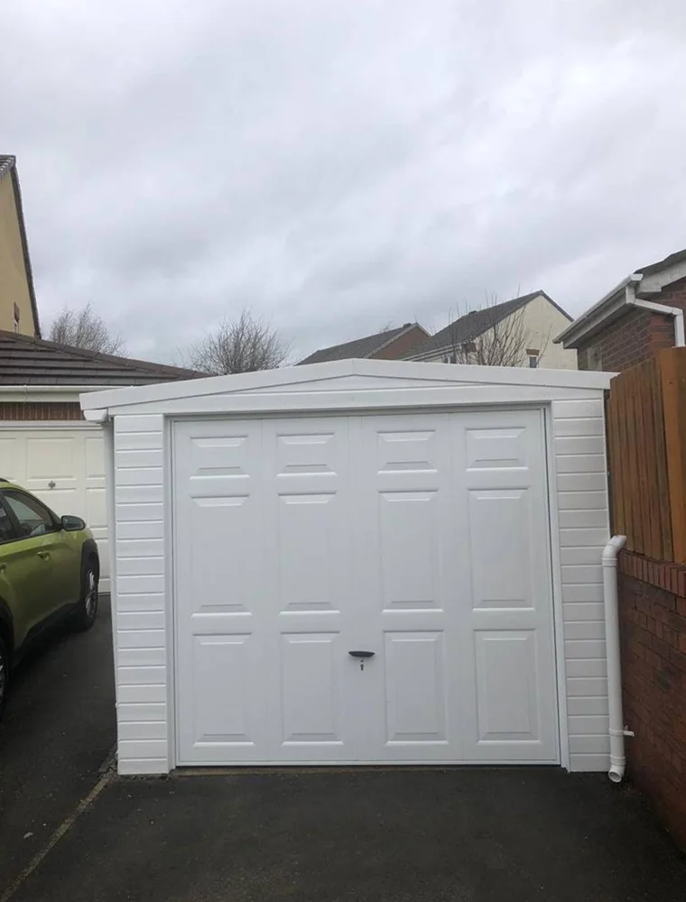 White Georgian-style up and over garage door fitted to a home